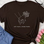 Soft Heart, Steady Hands T-Shirt — Minimalist Hand-Holding Nurse Design-Black / XS-YOUSTOMIZE
